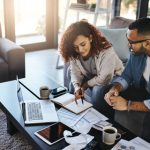 Shot of a young couple planning their budget together at home