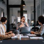 stock-photo-a-focused-mentor-is-explaining-project-to-mentees-at-the-boardroom-at-enterprise-2248210265